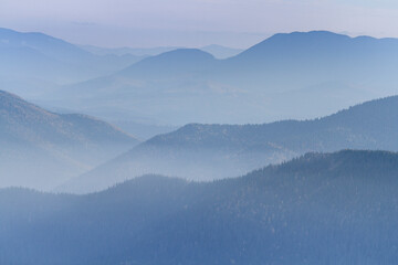 Mountain forest in the fog. Hiking travel outdoor concept panoramic view. Ukrainian Carpathian Mountains, Ukraine