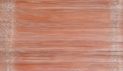 Bamboo panels in the background.