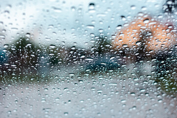 Drops of rain are on frontal glass of car
