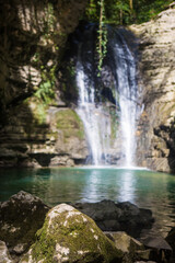 Fototapeta na wymiar blue mountain river with a waterfall
