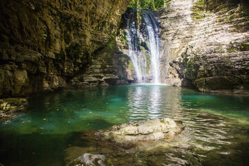 blue mountain river with a waterfall