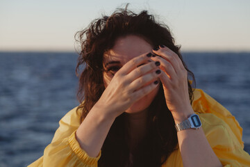 Portrait of beautiful brown-haired woman on background of sea