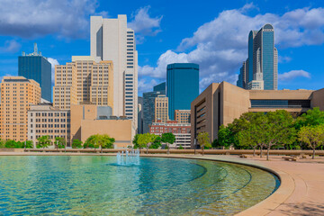 Fototapeta na wymiar Downtown Dallas buildings line a refreshing fountain courtyard rest area.