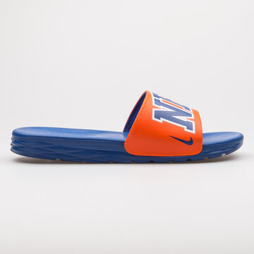 VIENNA, AUSTRIA - AUGUST 24, 2017: Nike Benassi Solarsoft NBA orange and blue sandal on white background.