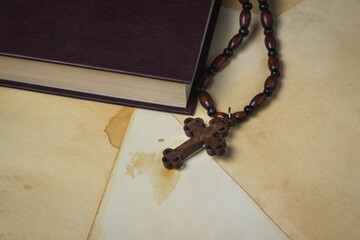 Religion concept. Christian religion. Wooden cross on a wooden chain. A cross lies next to the...