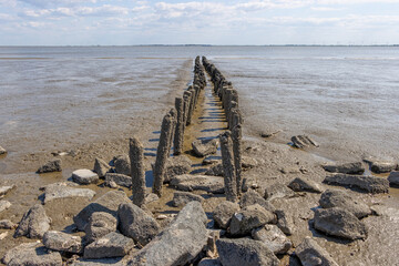 some Wooden platforms lead into the Wadden Sea of the North Sea