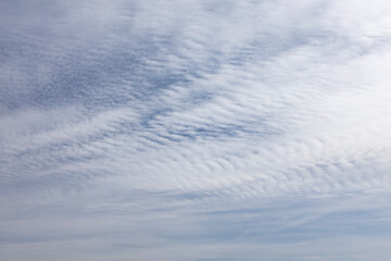 Cirrus clouds high in the blue sky, the background and texture