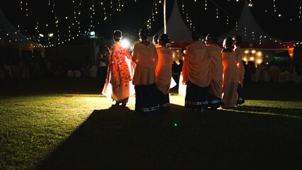 African wedding in Uganda, beautiful ladies in national clothes, bridesmaids with bride in the evening, nightlight decoration, magical wedding concept
