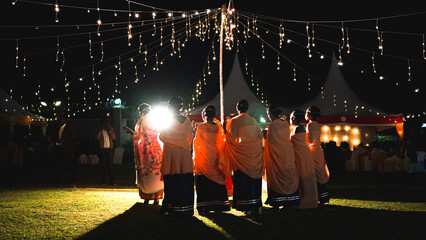 African wedding in Uganda, beautiful ladies in national clothes, bridesmaids with bride in the evening, nightlight decoration, magical wedding concept
