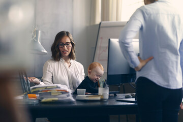 Business woman and mom is getting in trouble for bringing her baby to the office, making it hard...