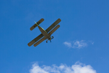 Retro military plane flies in the sky. Russia.