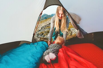 Baby and mother in camping tent family travel vacation adventure lifestyle child hiking with...