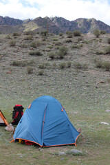 Tourists rafting along the river are built a tent camp on the shore of the mountain river "Chuya", the Republic of Altai, Russia. A wonderful scenic place with a mountain scenery.