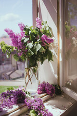 bouquet of violet lilac on a background of an old window