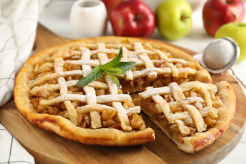 Tasty apple pie on white wooden background, close up. Homemade food