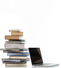 Elearning, books stack and a laptop isolated on white background