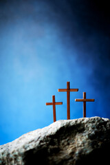 Three wooden cross on Calvary hill, blue background. Crucifixion, resurrection of Jesus Christ....