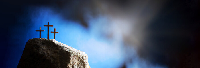 Crucifixion, resurrection of Jesus Christ. Three crosses against blue sky on Calvary hill...