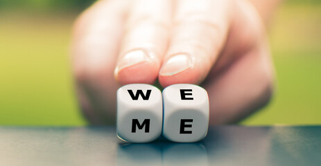 Teamwork concept. Hand turns dice and changes the word 