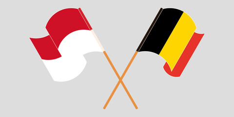 Crossed and waving flags of Indonesia and Belgium