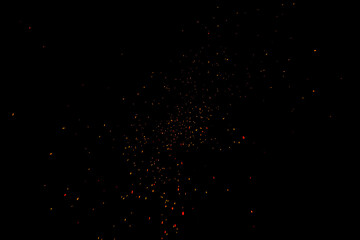 sparks from the fire on a black background