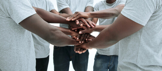 group of diverse guys making a tower out of hands