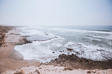 Vast scenic landscape of Atlantic Ocean coast in South Morocco. Paradise wild beach with rugged cliffs