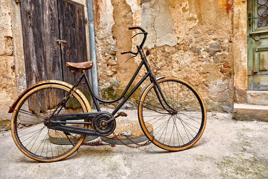Old retro bicycle on vintage street in Croatia background aged wall and wooden door. City Lovran.