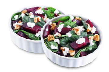 Spinach beet goat cheese walnuts salad on a white isolated background