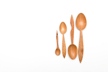 Houseware: wooden kitchen spoons, isolated on white background top view. Zero waste, eco friendly concept. Flat lay