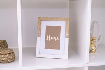 Frame inside a living room with the word home
