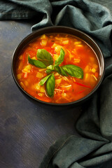 Minestrone traditional italian soup. Bowl of delicious vegetables soup on wooden table