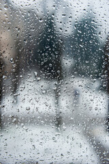 Drops of water on a window pane in a room.