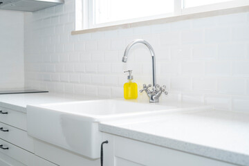 Fototapeta na wymiar Contemporany kitchen style faucet and ceramic sink