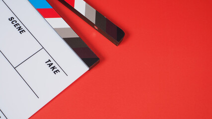 Clapperboard or movie slate on red background.it use in video production and film industry .