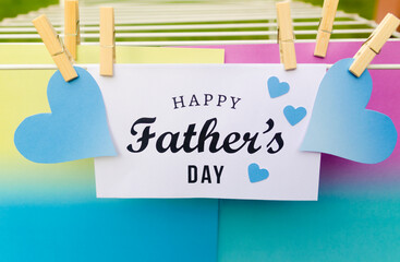 Hanging greeting card Happy Father's day with lettering and blue hearts