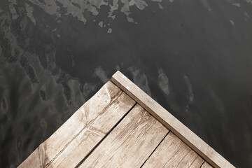 Wooden pontoon on the background of water in the lake