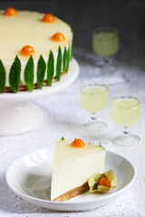 Mousse cake with cream, condensed milk and lime juice, garnished with jelly and physalis, served with limoncello.