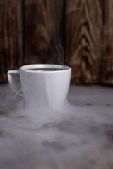 steaming cup of espresso coffee on a wooden table