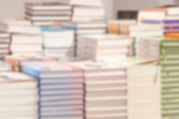 Stacks of books. Book sale point. Blurred image for background.