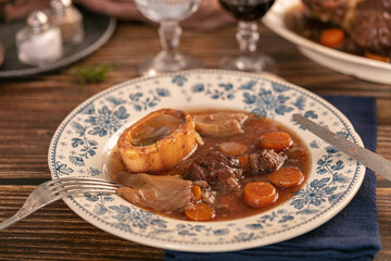 Well-cooked beef shank in wine sauce served in an antique plate