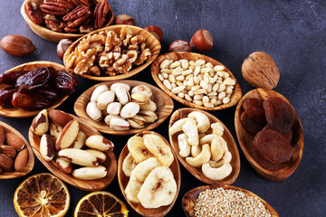 Composition with dried fruits and assorted healthy nuts in wooden bowls