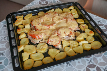 
French meat baked with potatoes at home, baking on the table