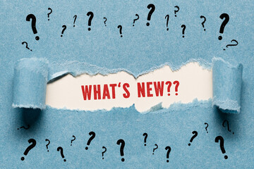 torn paper with many question marks revealing the question WHAT'S NEW?