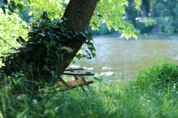 hölzerne Sonnenliegen auf dem Rasen am Fluss