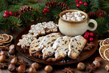 Christmas gingerbread  cookies with holiday  stollen and hot chocolate drink in mug with marshmallow