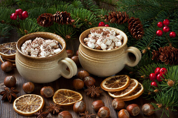 Obraz na płótnie Canvas Cups of creamy hot chocolate with melted marshmallows