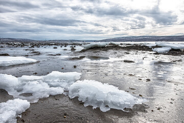 Pieces of freshwater ice at in the water near coast