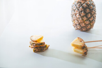 Soft white minimal and graded bright pineapple slices view with professional lighting