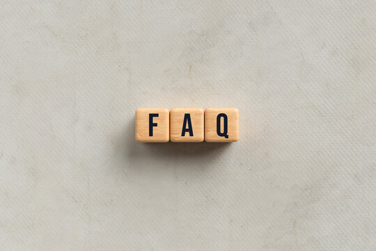 cubes with text FAQ on paper background